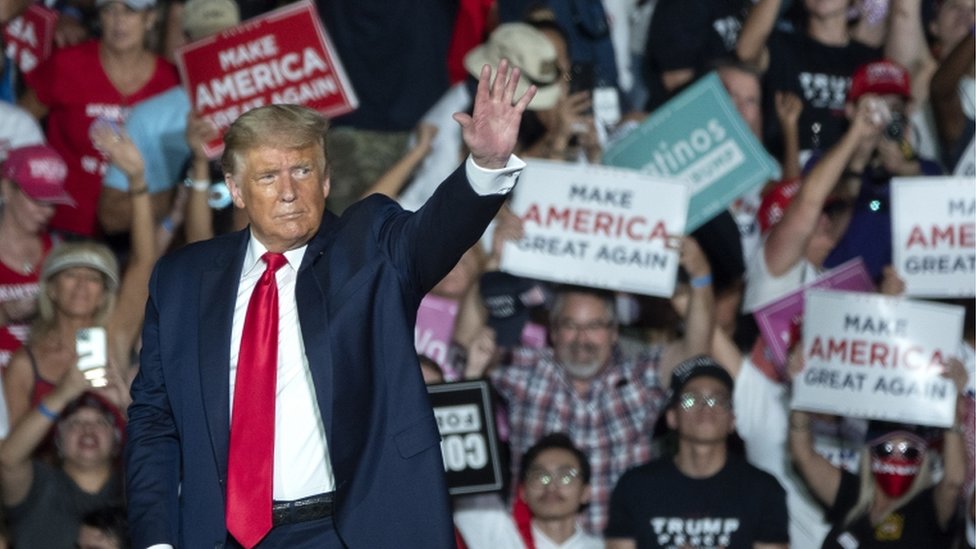 President Donald Trump waves to the crowd at a rally in Sanford, FL 12 October 2020
