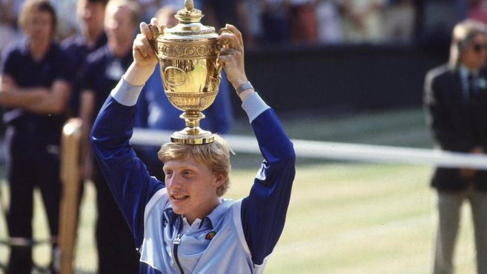 Boris Becker holds his 1985 Wimbledon men's singles trophy aloft