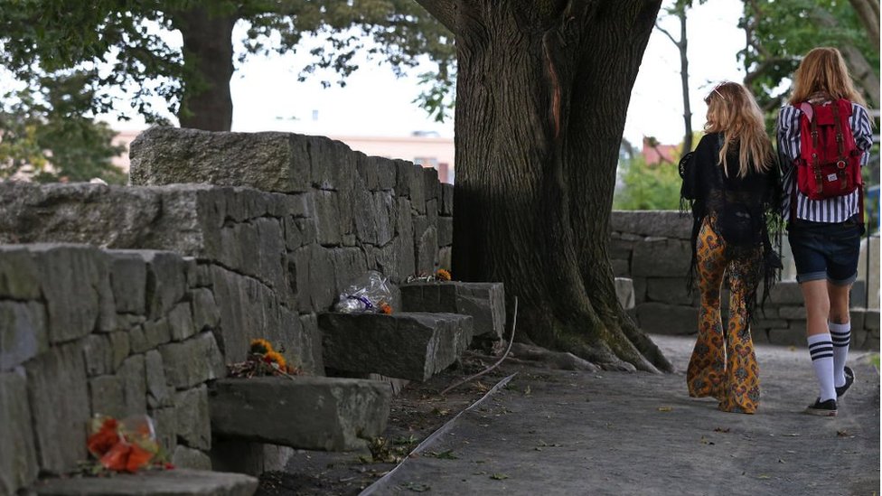 Visitors walk through the Salem Witch Memorial in Salem, Massachusetts on Sep. 26, 2019