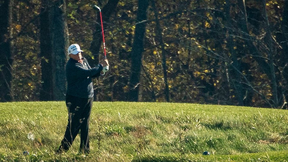 Donald Trump playing golf.