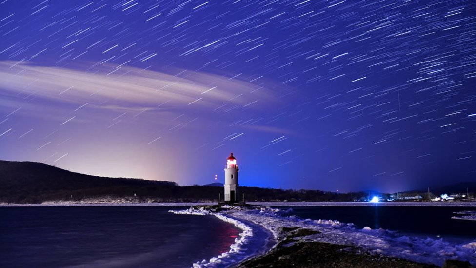The Geminids meteor shower during its peak, in the night sky over Tokarevsky Lighthouse on Egersheld Cape on Russky Island in the Sea of Japan, December 2017.