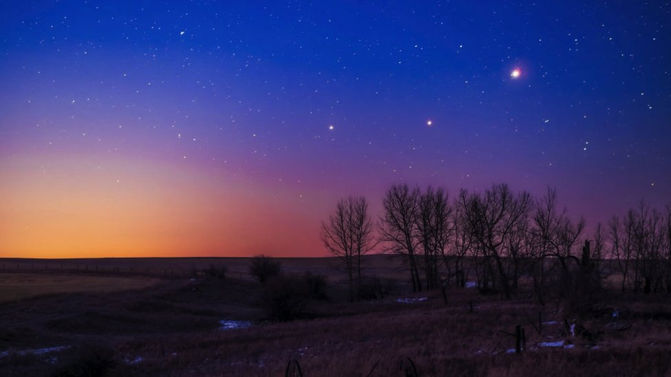 The trio of (L to R) Saturn, Mars and Jupiter in conjunction in the dawn twilight, taken from home in Alberta on March 26, 2020. This is a stack of 10 exposures.