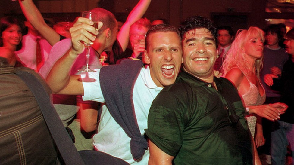 A fan smiles and hugs Diego Maradona during a party at the Conrad Hotel in 1999 in Punta del Este, Uruguay