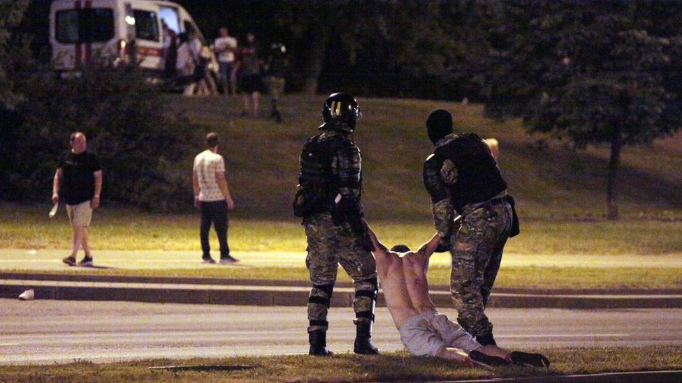 Police arrest a demonstrator in Minsk on 9 August