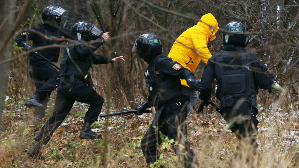 Police chase a demonstrator in Belarus on 22 November