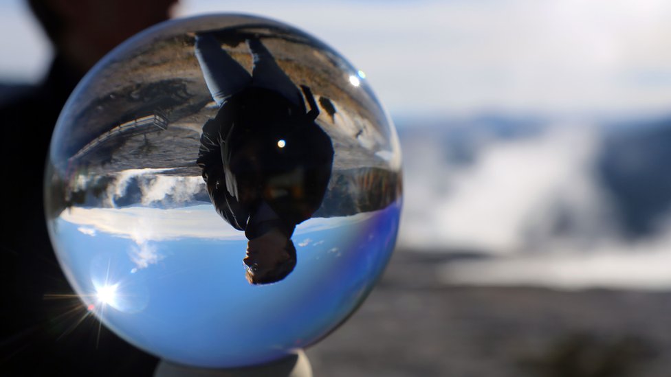 Man seen through a crystal ball