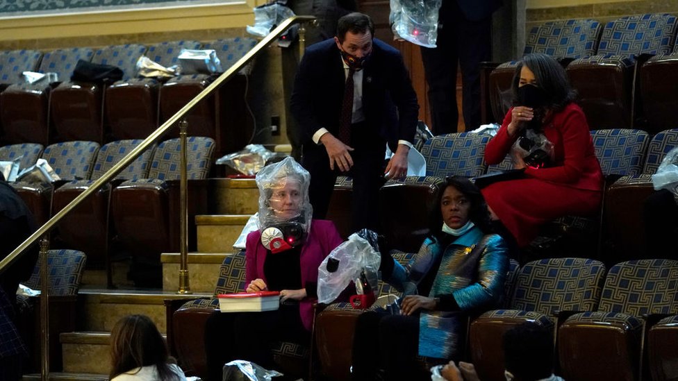 US lawmakers and staff wear protective gear amid protests inside the Capitol