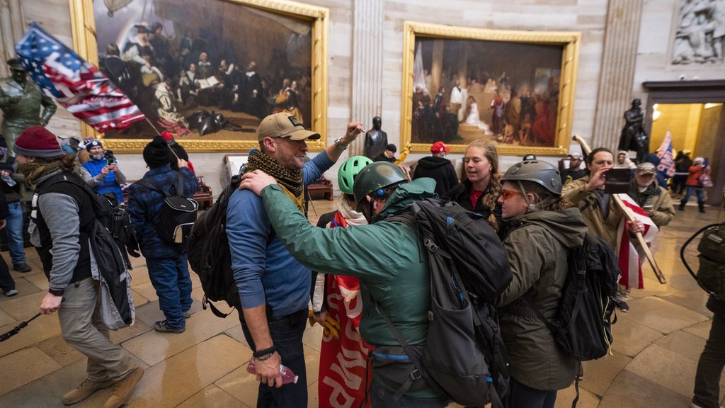 Supporters of US President Donald J. Trump in the Capitol rotunda after breaching security
