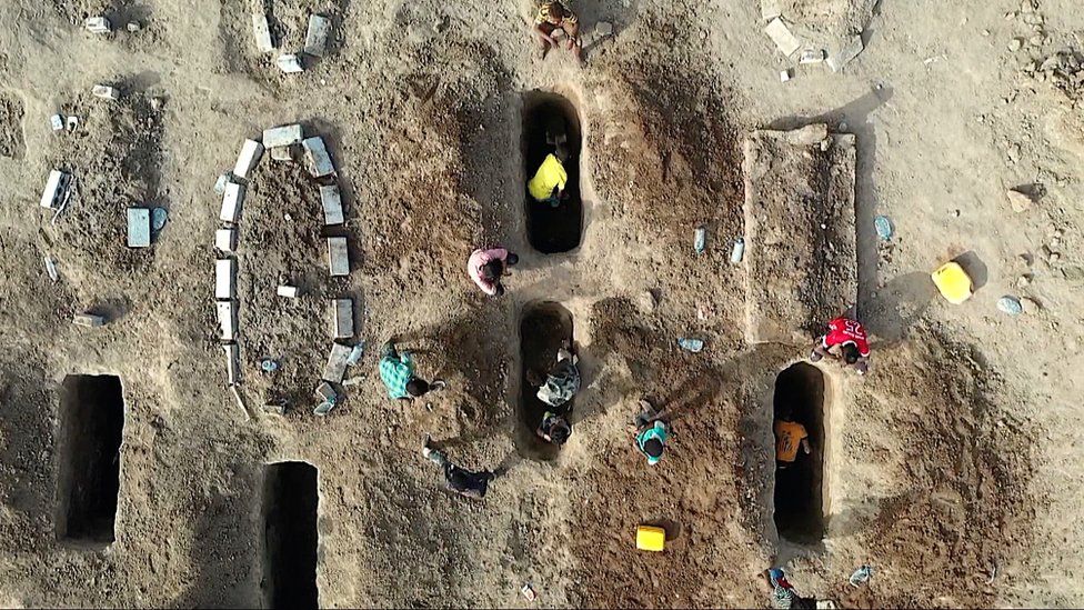 Digging graves in al-Radwan cemetery