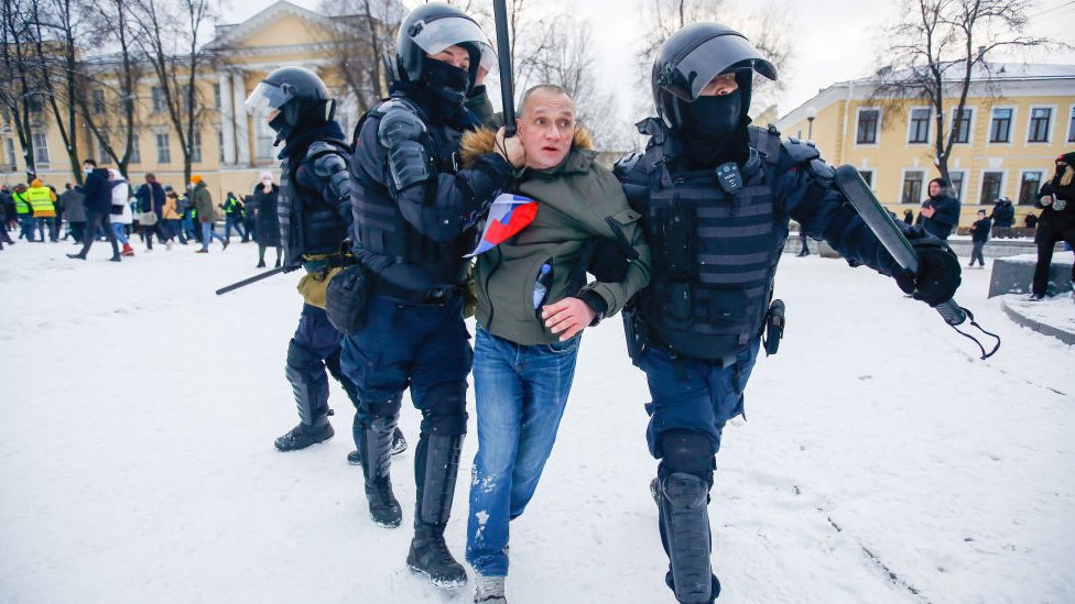 Police officers detain a protester in St Petersburg