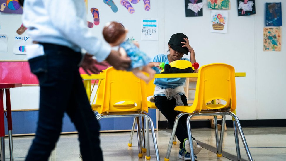A girl is sitting in one of the classrooms at the South Texas Family Residential Center in 2019.