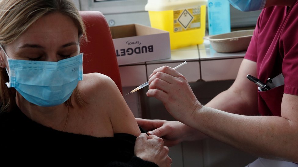 A woman is vaccinated against Covid-19 in Paris, France