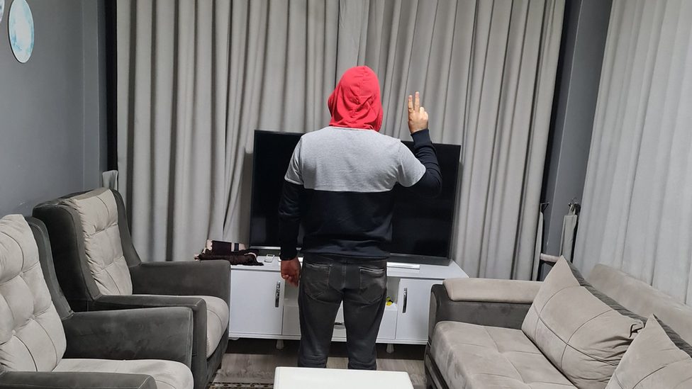 Noor with his back to the camera