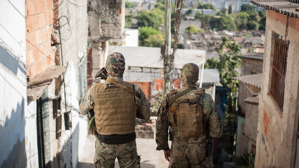 Two armed police officers in a favela