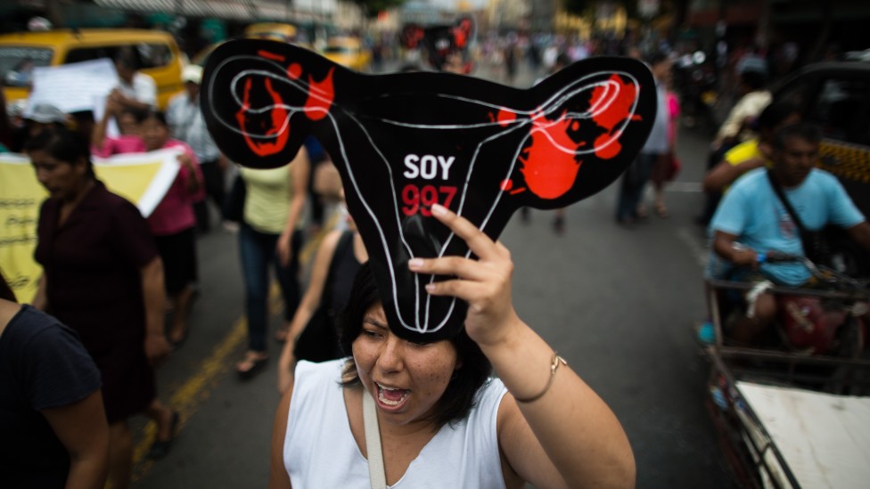 A women holds a plastic bloody ovary during a protest in front of the prosecutor's office in 2016
