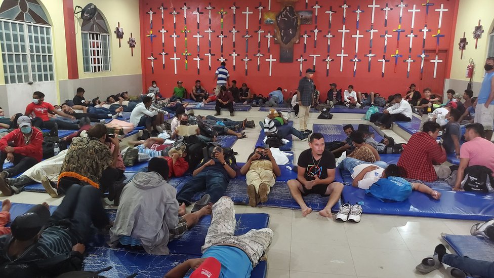 People lie on mats in the migrant shelter in Tenosique