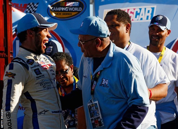 Wendell Scott Jr congratulates Bubba Wallace on a 2013 victory, with Warrick also present