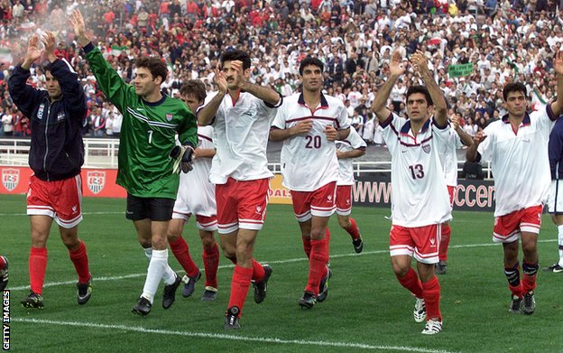 Iran players, wearing the USA shirts they have swapped, acknowledge the Rose Bowl crowd after their 1-1 draw