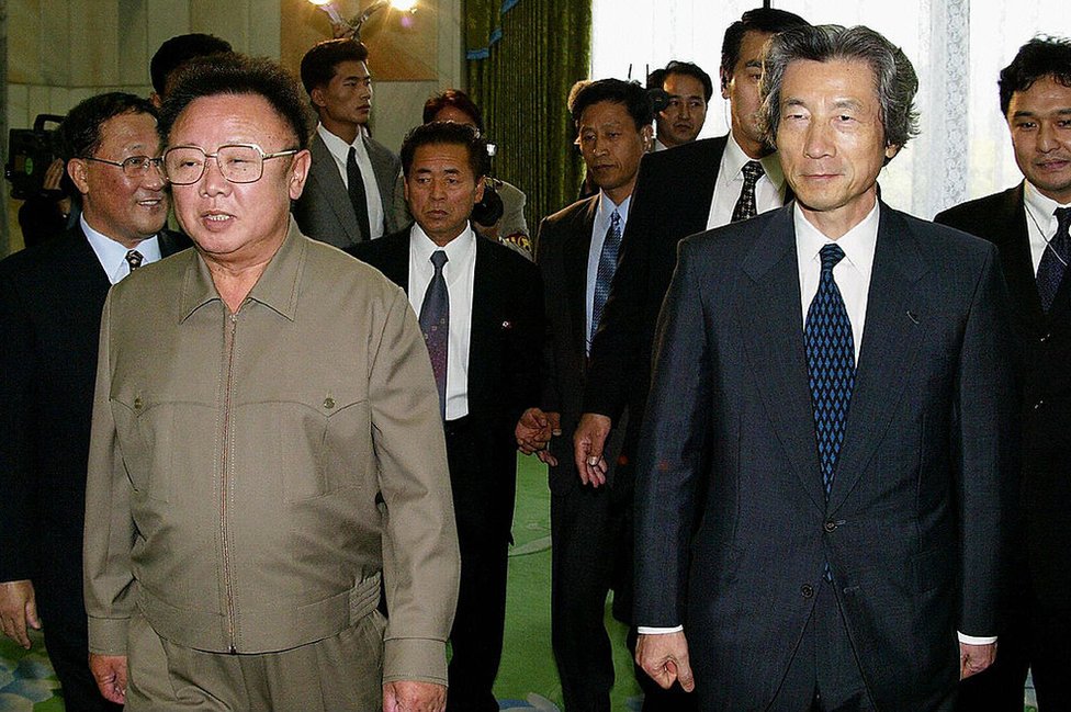 Japanese Prime Minister Junichiro Koizumi walks with North Korean leader Kim Jong-Il before their talks in Pyongyang on 17 September 2002.