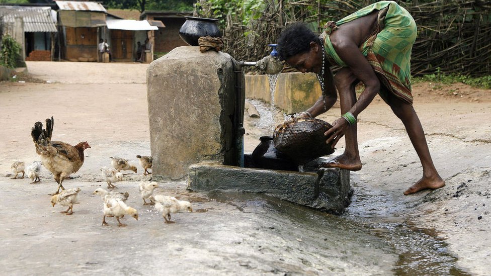 An Indian woman washes her utensils in Kanjeriguda village, Orissa state, India during an outbreak of diarrheal diseases in 2007