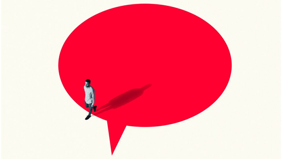 Concept image: Man walking out from vibrant red speech bubble -