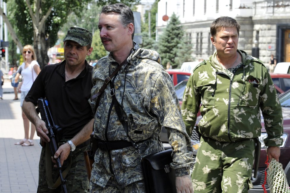 Igor Girkin, aka Strelok (C), walks with his bodyguards in the eastern Ukrainian city of Donetsk on 11 July 2014