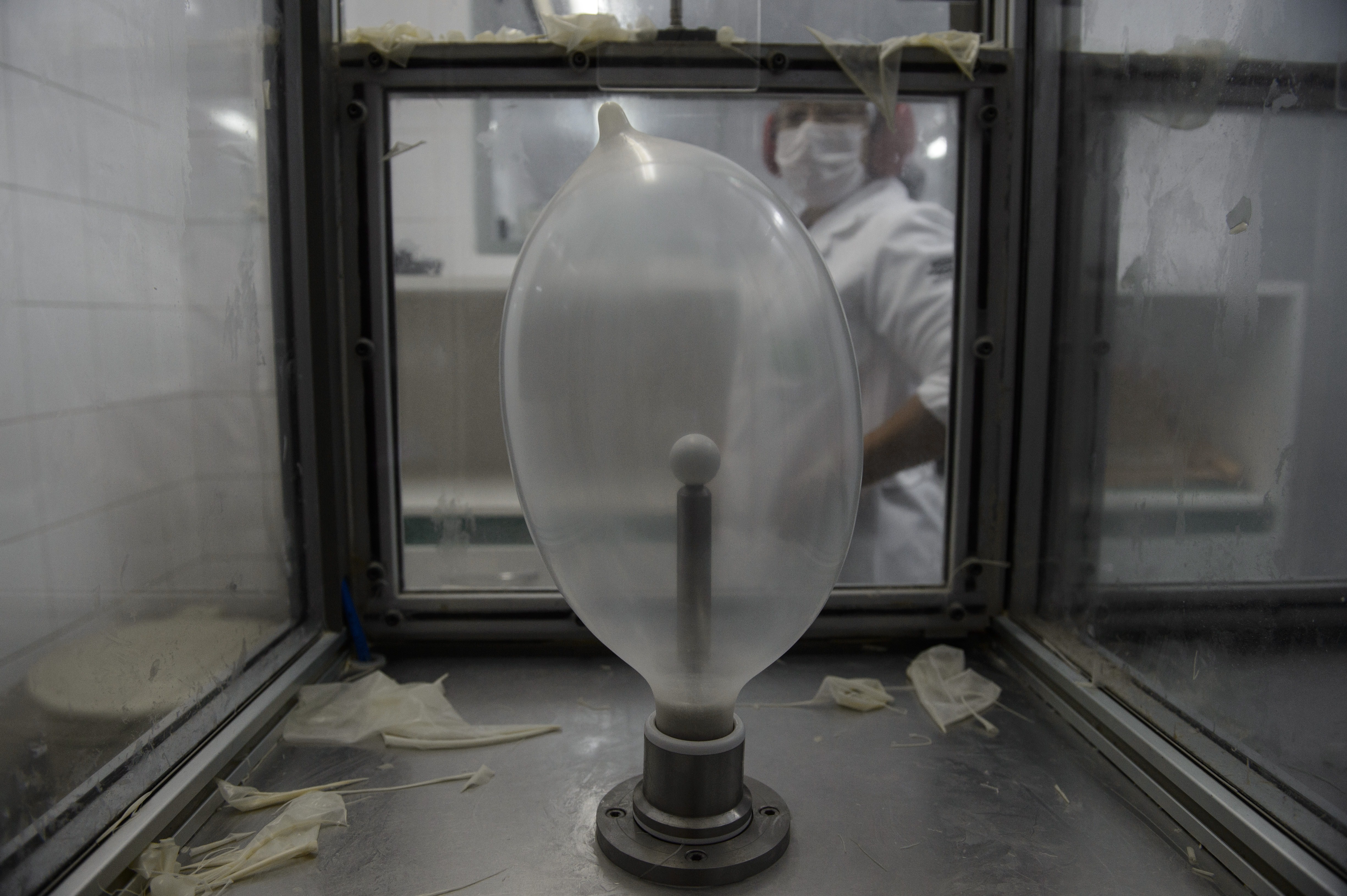 Samples of condoms are tested by inflating them in a chamber at the Natex factory in Brazil