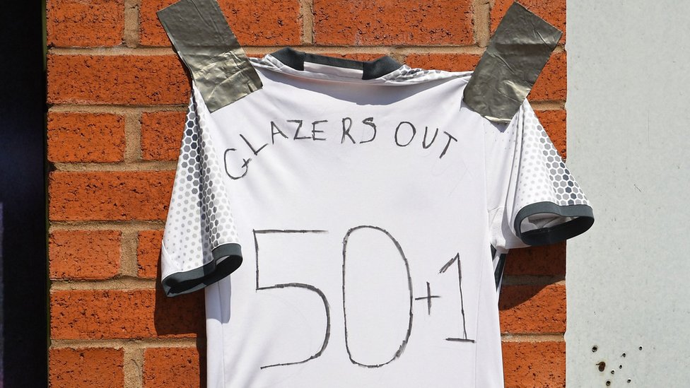 'Glazers Out' written on a shirt outside Old Trafford