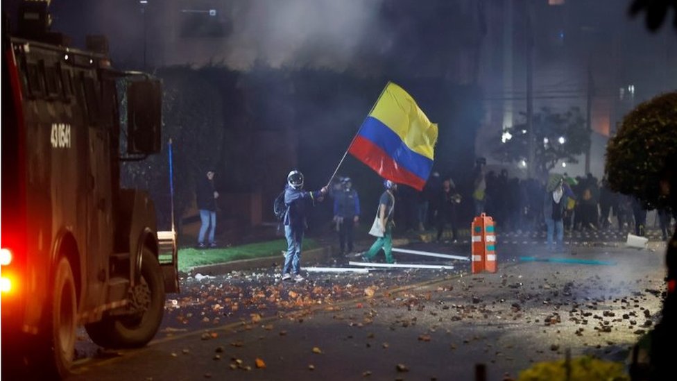 Members of the Mobile Anti-Riot Squad (ESMAD) confront protesters who arrive in the neighborhood where the President of Colombia Ivan Duque has his residence, during a day of protests against the tax reform, in Bogota, Colombia, 01 May 2021.
