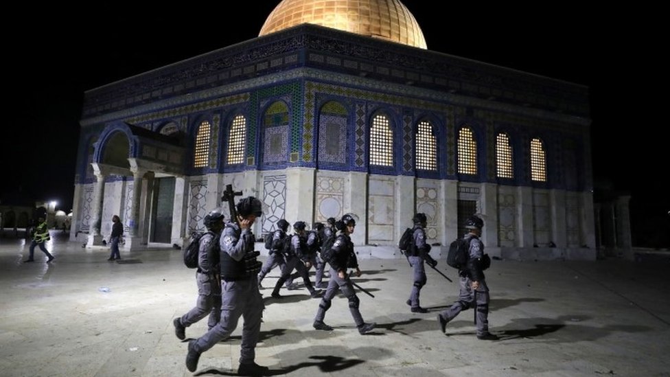 Israeli police walk near the Dome of the Rock during clashes with Palestinians, 7 May