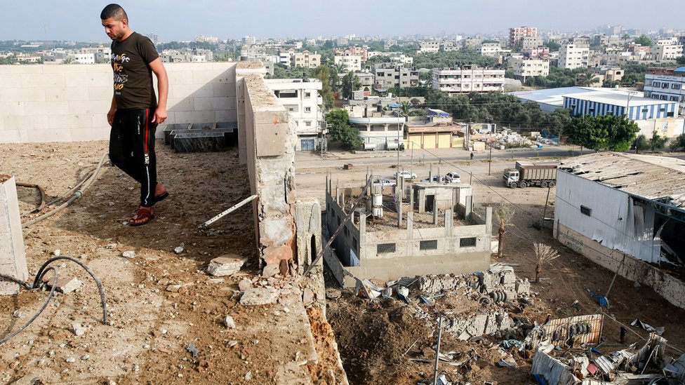 Man stands by rubble in Gaza