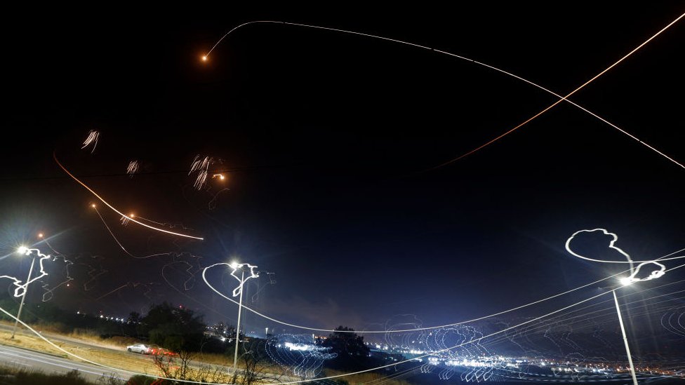 The Iron Dome intercepting missiles at night sky