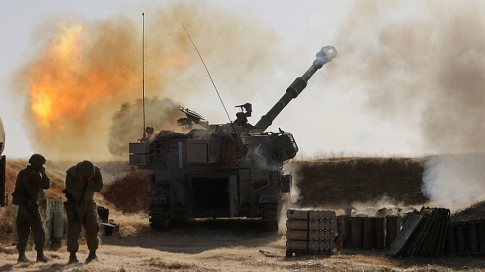 Israeli soldiers fire towards targets in the Gaza Strip on 12 May