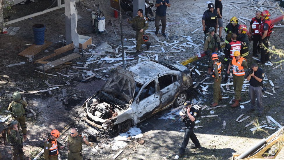 Police and rescue teams at the scene of a direct rocket hit in Ramat Gan, Israel, 15 May 2021