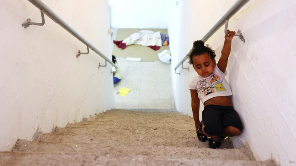 A child walks on stairs inside a bomb shelter in Ashkelon, southern Israel, on May 16