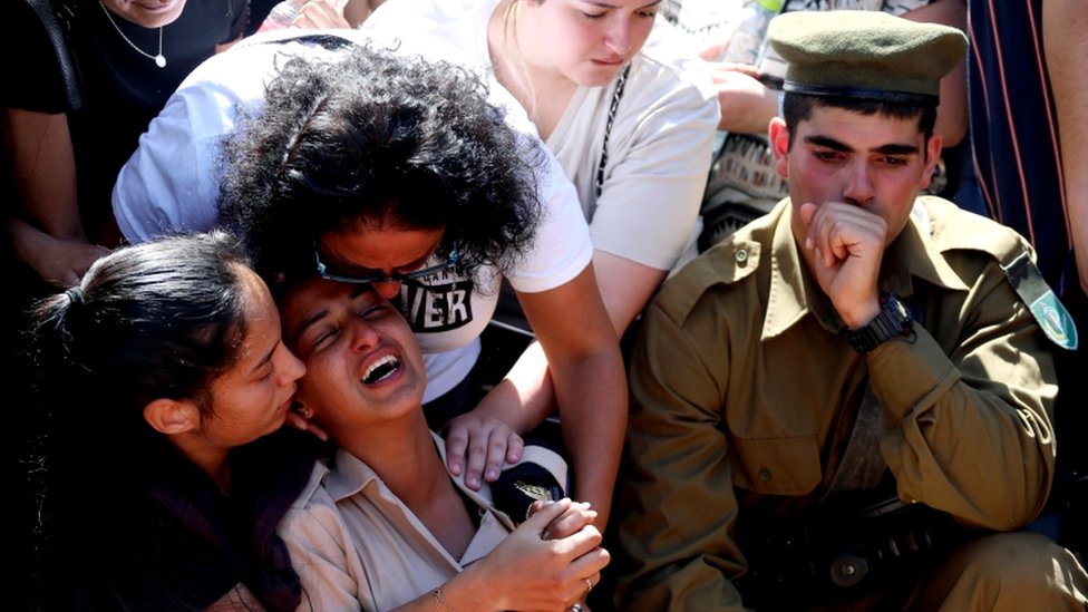 Family and friends, including Israeli soldiers, mourn during the funeral of Israeli soldier Omer Tabib, who was killed during cross-border fighting with Gaza