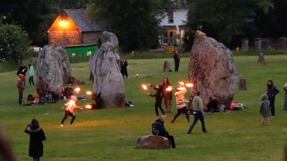 Revellers celebrate the Summer Solstice, despite official events being cancelled amid the spread of the coronavirus disease (COVID-19), in Avebury