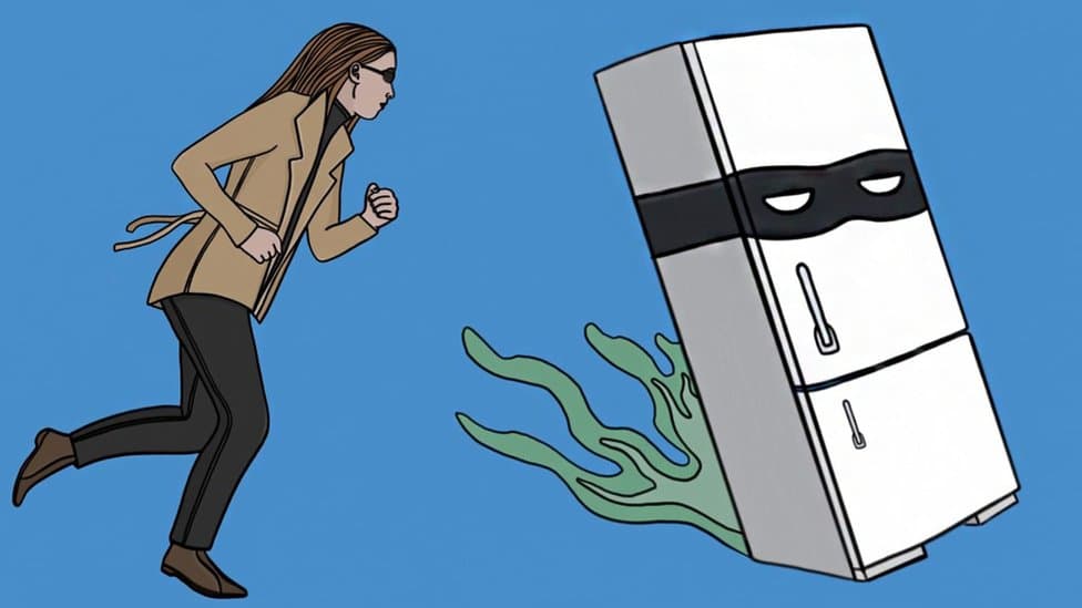 A woman chasing a fridge wearing a villain's face