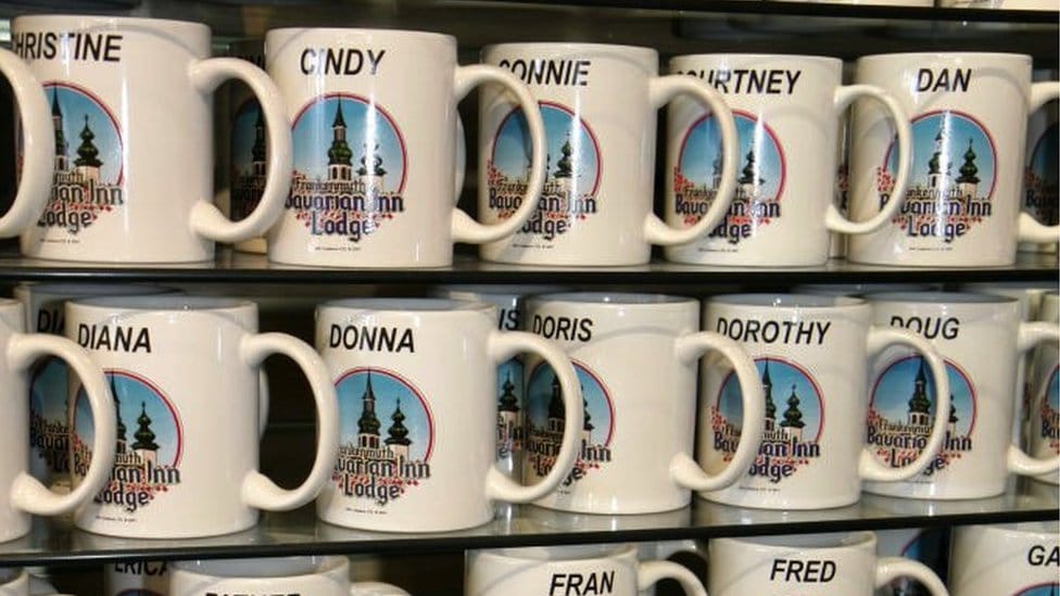 Named mugs for sale on a shop shelf