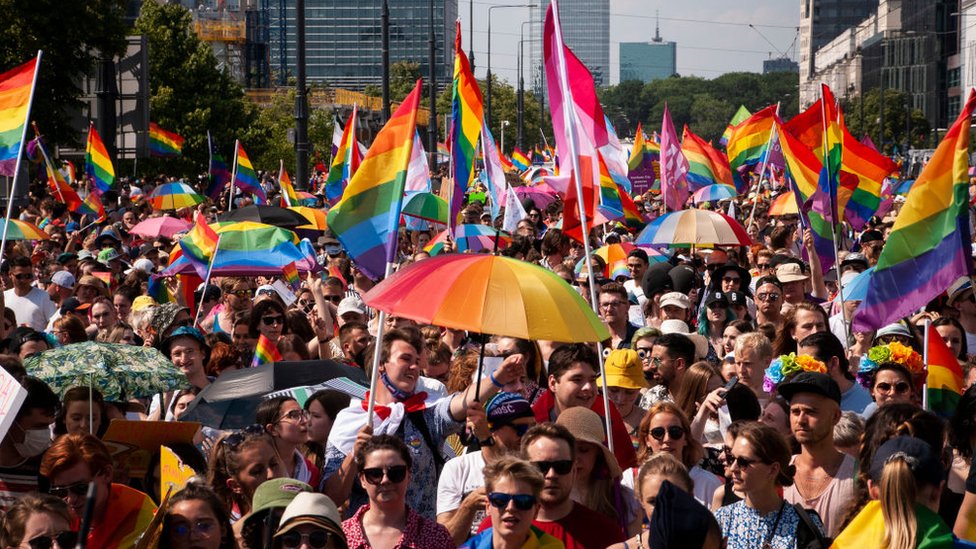 Crowd with LGBT rainbow flags in Warsaw