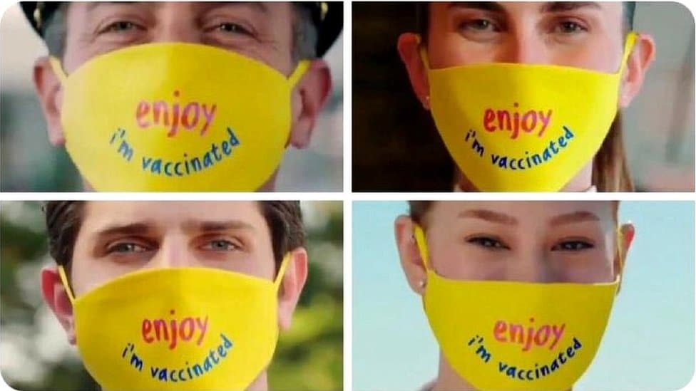 Yellow masks with 'Enjoy, I am vaccinated' written on them
