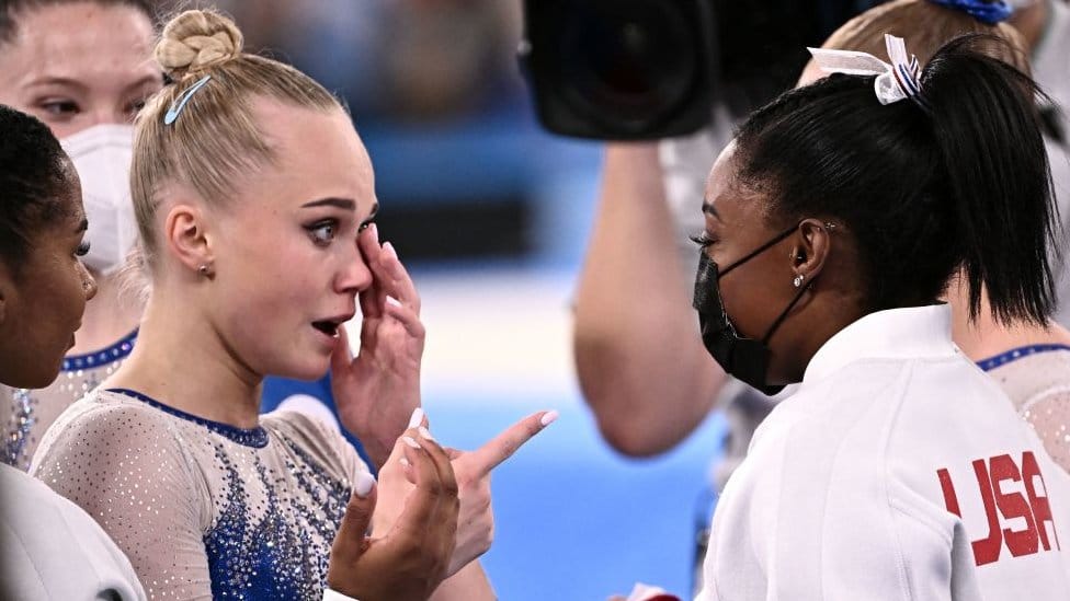 Russia's Angelina Melnikova (L) is congratulated by USA's Simone Biles as Russia wins the artistic gymnastics women's team final during the Tokyo 2020 Olympic Games