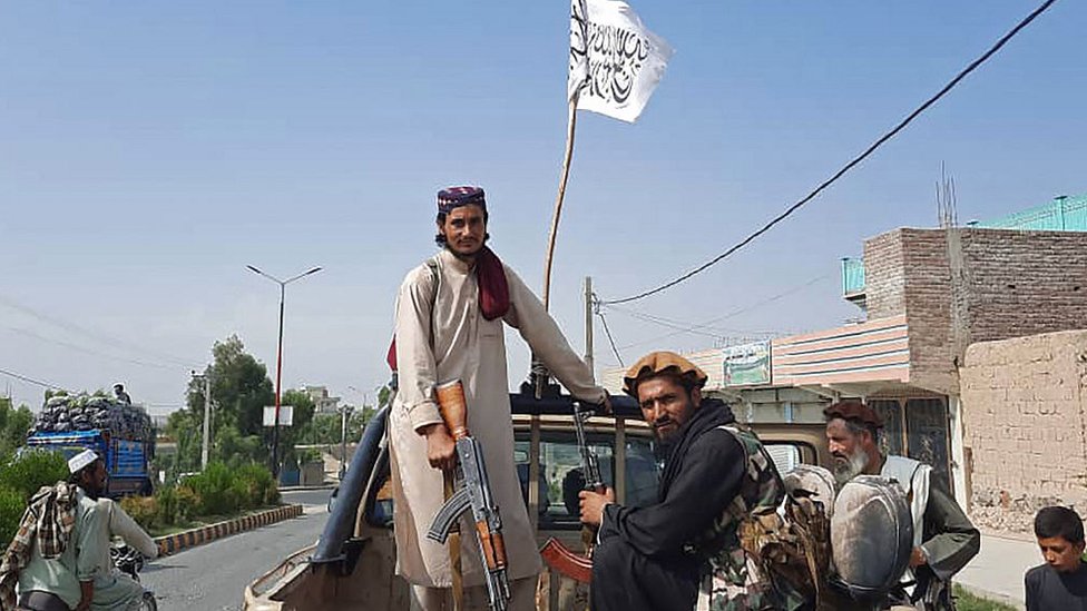 Taliban fighters drive an Afghan National Army (ANA) vehicle through the streets of Laghman province on August 15, 2021