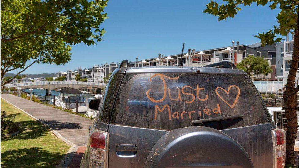 South Africa, Just married sign with a heart painted on the rear window of a car.