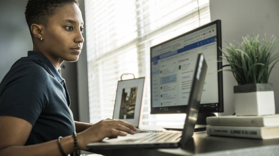 Woman typing at a computer