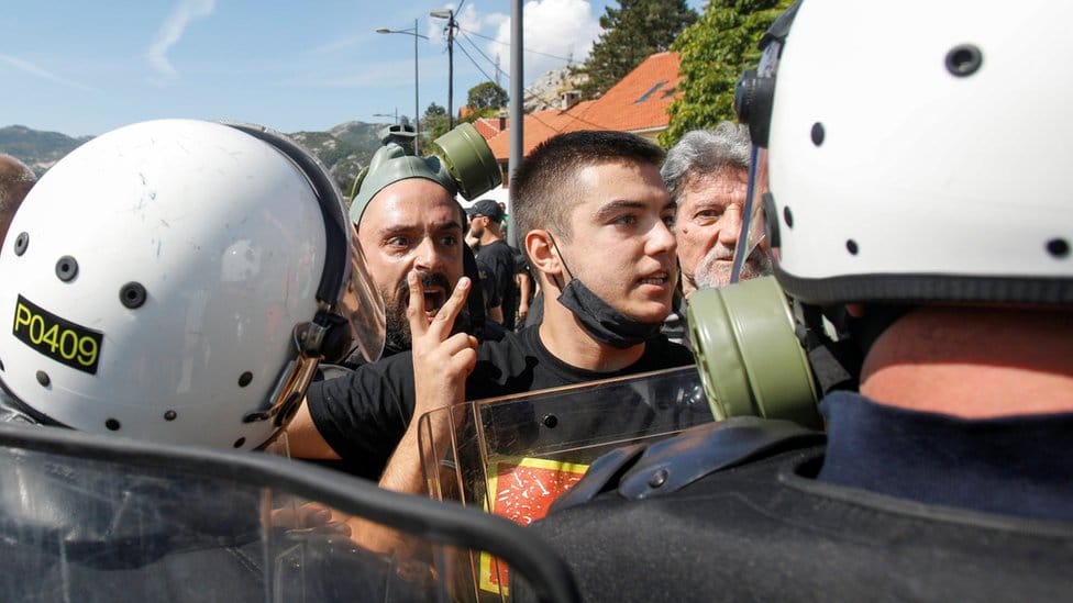 Demonstrators argue with police during a protest against enthronement of Bishop Joanikije in Cetinje