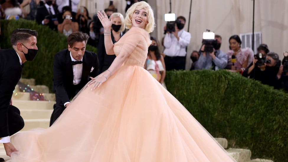 Billie Eilish waves to the crowd in a peach outfit that drew comparisons with Marilyn Monroe