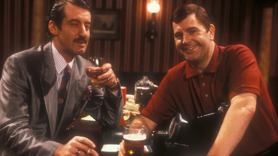 John Challis, pictured here playing Boycie (L)