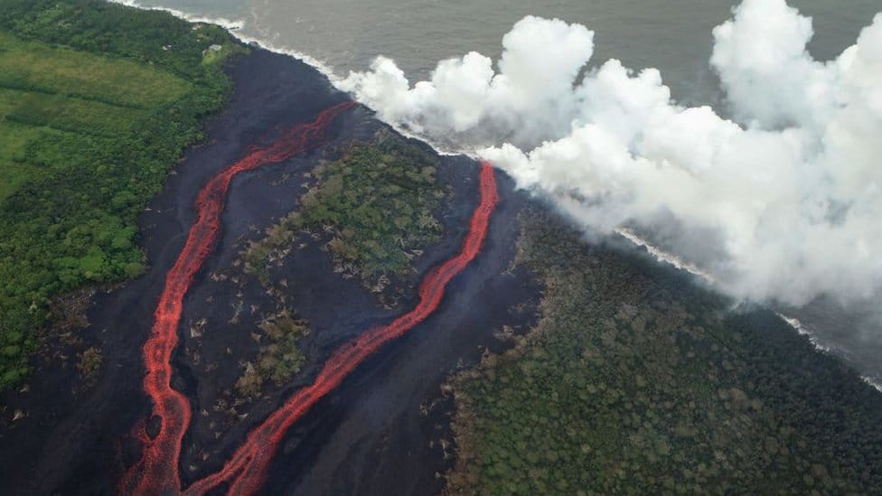 Steam plumes rise as lava enters the Pacific Ocean, after flowing to the water from a Kilauea volcano fissure, on Hawaii's Big Island on May 21, 2018 near Pahoa, Hawaii.