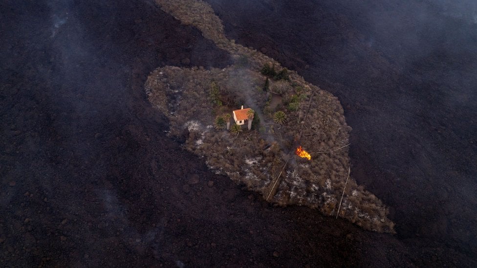 A house sits surrounded by lava in La Palma